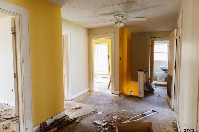 misc room featuring ceiling fan and a textured ceiling