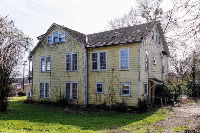 rear view of property featuring a yard