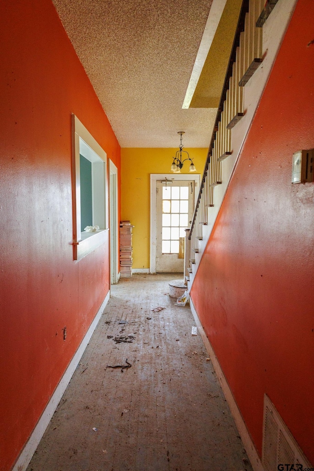 hallway featuring a textured ceiling