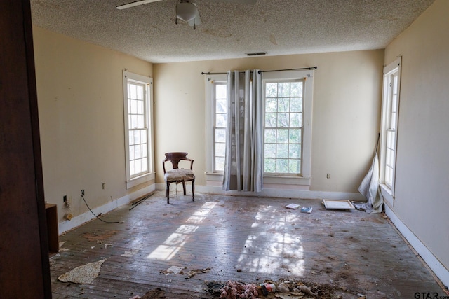 unfurnished room featuring a textured ceiling and ceiling fan