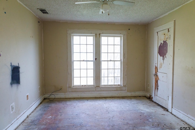 spare room with ceiling fan and a textured ceiling