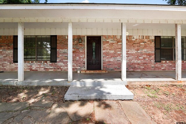 260 County Road 2302, Rusk, TX 75785 - property entrance featuring a porch and brick siding