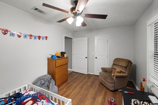 260 County Road 2302, Rusk, TX 75785 - bedroom with wood finished floors, a textured ceiling, a ceiling fan, and baseboards