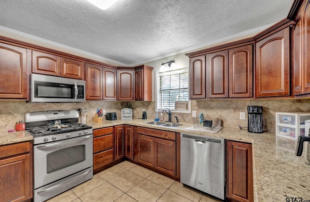 260 County Road 2302, Rusk, TX 75785 - kitchen with stainless steel appliances, crown molding, a sink, backsplash, and light tile patterned floors