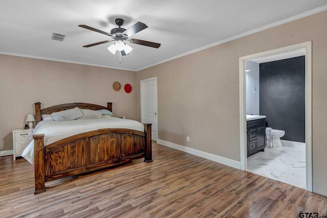260 County Road 2302, Rusk, TX 75785 - bedroom with wood finished floors, crown molding, baseboards, ensuite bathroom, and ceiling fan