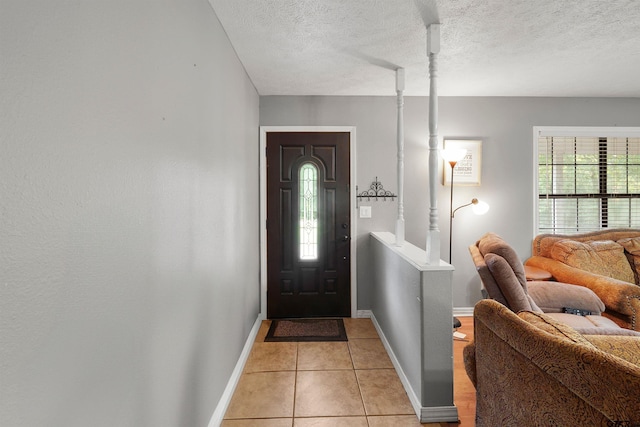 260 County Road 2302, Rusk, TX 75785 - foyer featuring baseboards, a textured ceiling, and light tile patterned floors