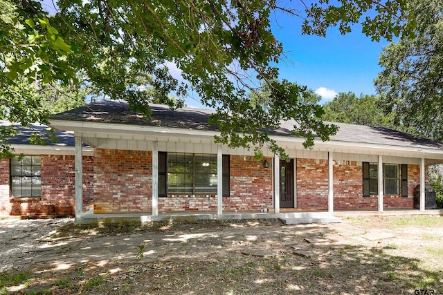 260 County Road 2302, Rusk, TX 75785 - ranch-style home with a porch, brick siding, and roof with shingles