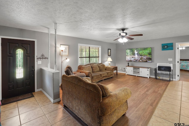 260 County Road 2302, Rusk, TX 75785 - living room with a ceiling fan, light wood-type flooring, baseboards, and a textured ceiling