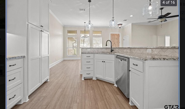 kitchen featuring visible vents, dishwasher, ornamental molding, ceiling fan, and light wood-style floors