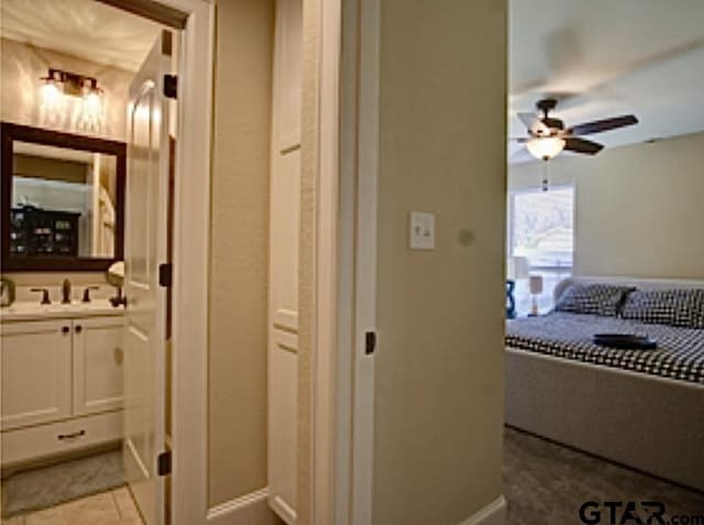 bathroom featuring vanity, baseboards, and a ceiling fan