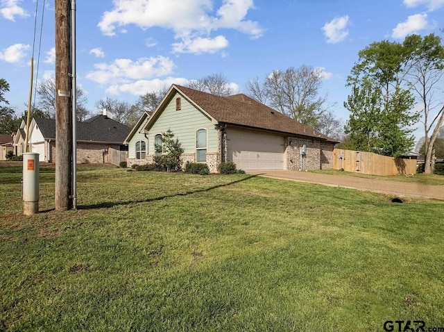 view of side of home featuring a lawn, fence, brick siding, an attached garage, and concrete driveway
