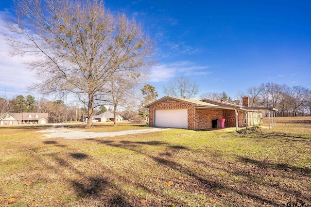 exterior space featuring a garage and a yard