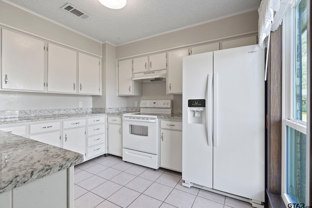 kitchen with white appliances, white cabinets, light tile patterned floors, a textured ceiling, and ornamental molding