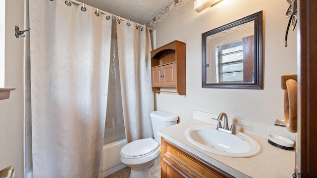 full bathroom with vanity, shower / tub combo, a textured ceiling, and toilet