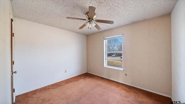 unfurnished room with ceiling fan, carpet flooring, and a textured ceiling