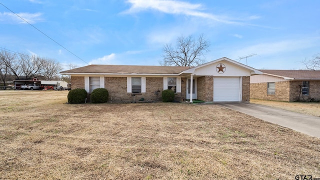 ranch-style house featuring a garage and a front lawn