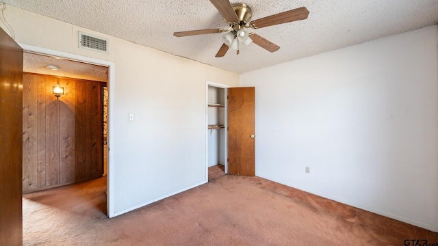 unfurnished bedroom with ceiling fan, a closet, carpet, and a textured ceiling