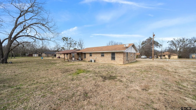 rear view of house featuring a lawn