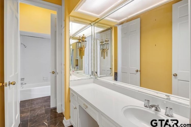 bathroom featuring marble finish floor and vanity