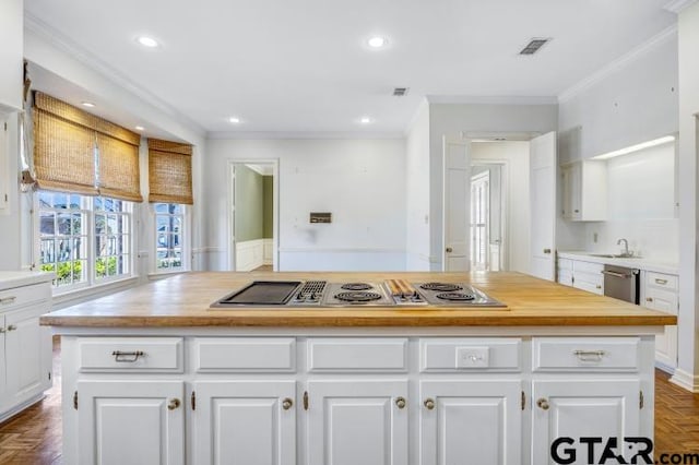 kitchen featuring a center island, butcher block counters, and white cabinetry