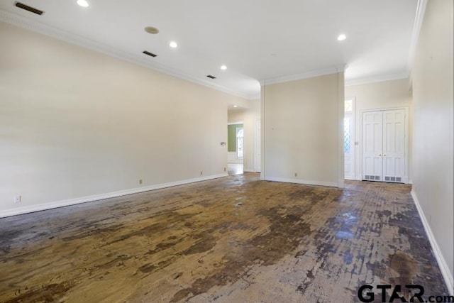 empty room featuring dark wood finished floors, visible vents, crown molding, and baseboards