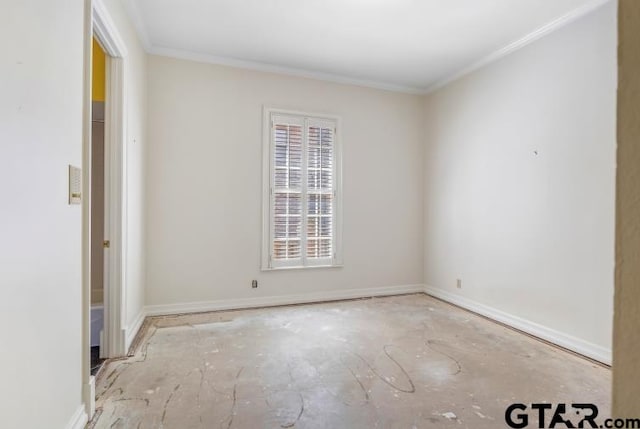 spare room with ornamental molding and baseboards