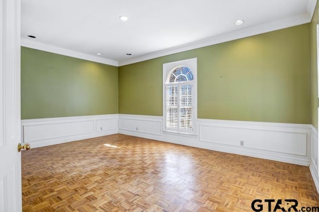 spare room with recessed lighting, ornamental molding, and wainscoting