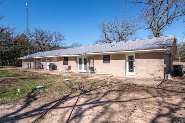 110 Vz County Road 2121, Canton, TX 75103 - back of property with a patio area, metal roof, and brick siding