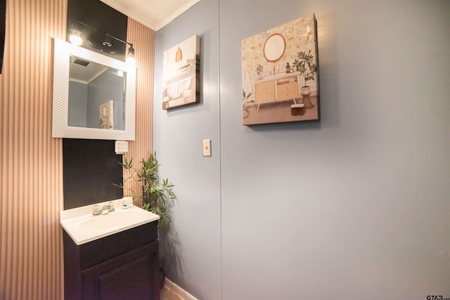 bathroom with ornamental molding and vanity