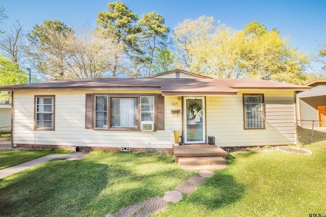 single story home with a front yard and fence