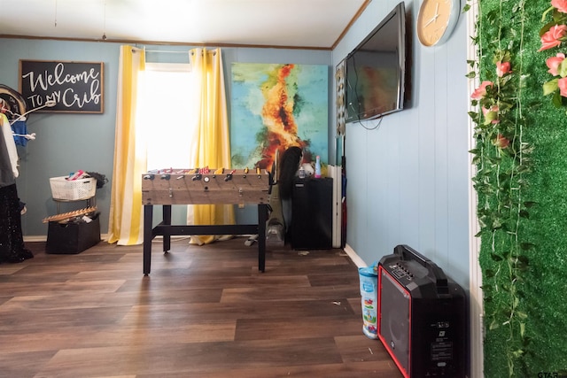 living area with crown molding and wood finished floors