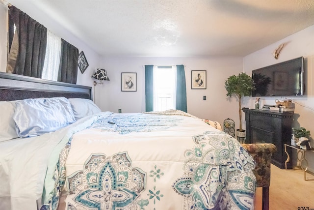 carpeted bedroom with a textured ceiling