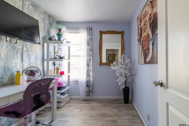 office space with baseboards and wood finished floors