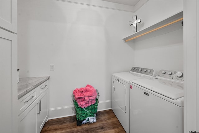 washroom with baseboards, washer and dryer, and dark wood-style flooring