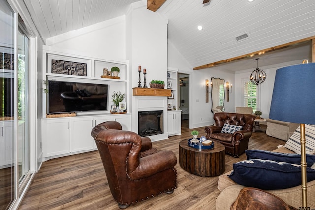 living area featuring wooden ceiling, wood finished floors, a chandelier, and visible vents