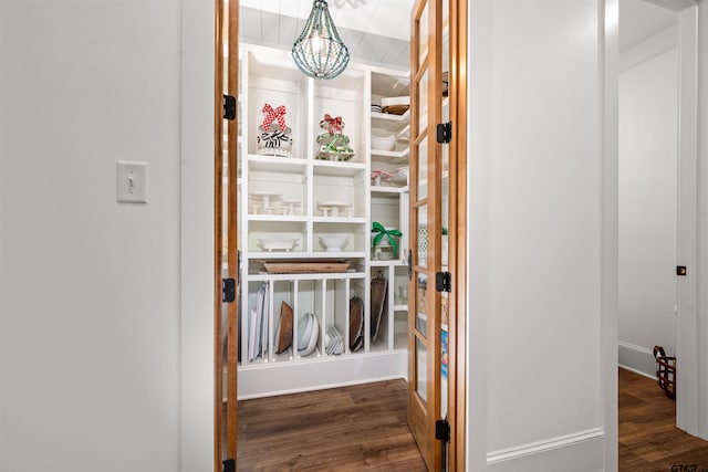 interior space with a chandelier and wood finished floors