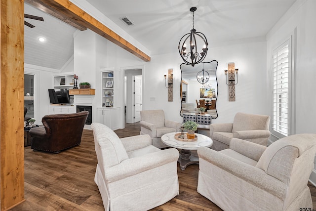 living area featuring visible vents, a chandelier, vaulted ceiling, wood finished floors, and built in features