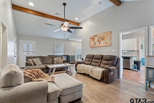 living room featuring high vaulted ceiling, light hardwood / wood-style flooring, a textured ceiling, beamed ceiling, and ceiling fan