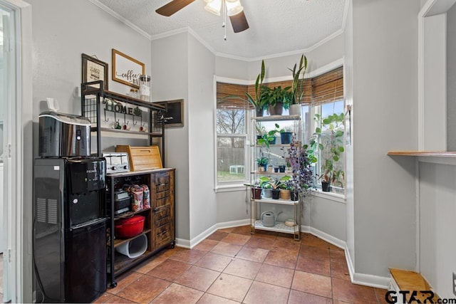 interior space featuring tile patterned flooring, crown molding, ceiling fan, and a textured ceiling