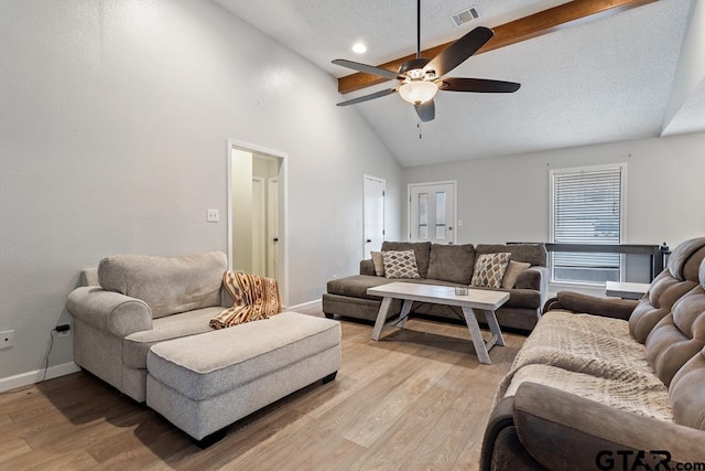 living room featuring ceiling fan, high vaulted ceiling, light hardwood / wood-style floors, a textured ceiling, and beamed ceiling