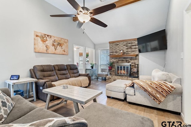 living room featuring ceiling fan, a brick fireplace, high vaulted ceiling, and light hardwood / wood-style floors