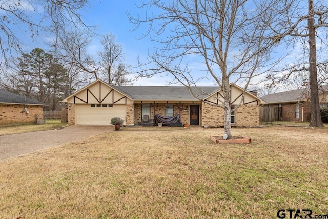 view of front of home with a garage and a front lawn