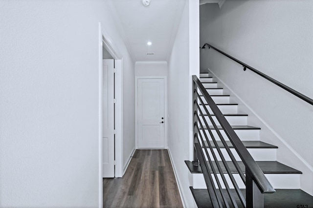 stairway featuring wood-type flooring and ornamental molding