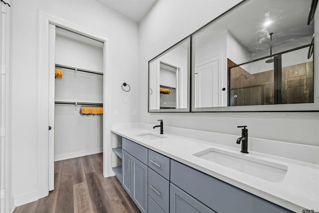 bathroom with an enclosed shower, vanity, and hardwood / wood-style flooring