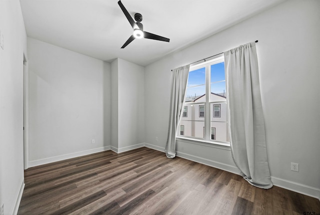 empty room featuring ceiling fan and dark hardwood / wood-style floors