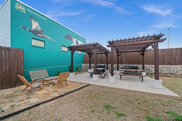 view of patio with grilling area, a pergola, and an outdoor living space