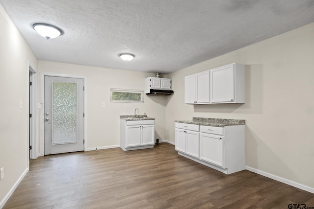 laundry area with hardwood / wood-style flooring, sink, and a textured ceiling