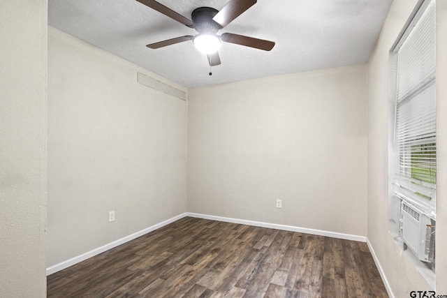 spare room featuring cooling unit, dark wood-type flooring, and ceiling fan