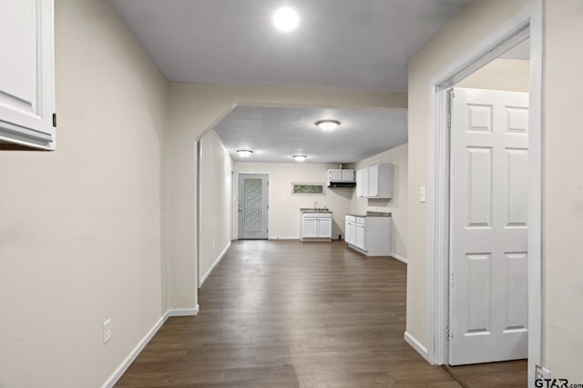 corridor with dark hardwood / wood-style floors