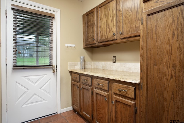 17617 Carol Cir, Flint, TX 75762 - kitchen featuring tile patterned floors, brown cabinets, and light stone counters